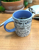 Katie Merz Mug with Blue Handle and Glyph Art