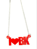 Red necklace with an 'I heart BK' pendant