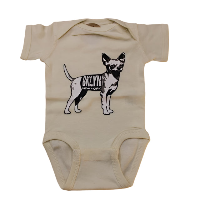 A beige colored onesie with a black printed dog design and the text 'BKLYN' on it.