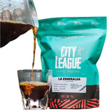 City League coffee bag with a glass of coffee being poured from it.