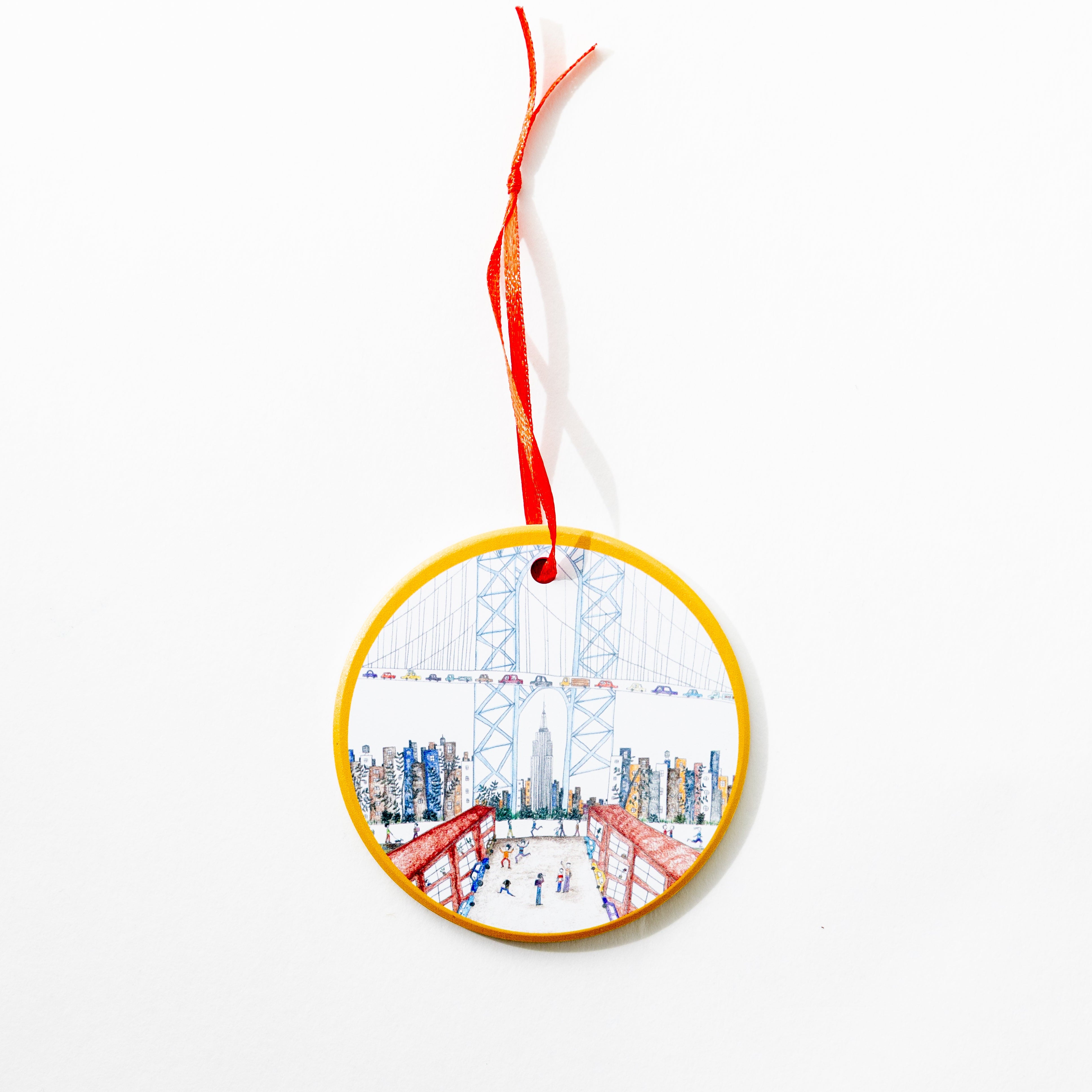 Natchie artist round ceramic decorative ornament with an illustration of the famous DUMBO view of the Manhattan bridge with the Empire State Building.