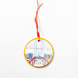 Natchie artist round ceramic decorative ornament with an illustration of the famous DUMBO view of the Manhattan bridge with the Empire State Building.