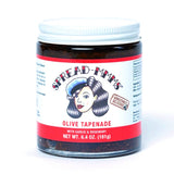 Jar of Spread-Me-Olive Tapenade with garlic and rosemary on a white background