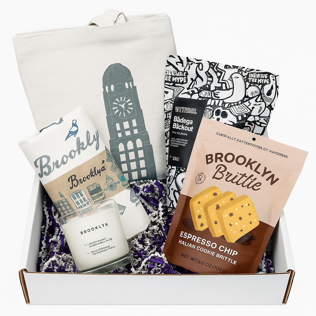 Gift box with Brooklyn-themed items including a candle, tote bag, and cookie brittle.