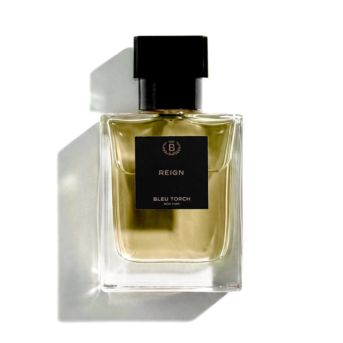 Perfume bottle labeled 'REIGN' on a white background