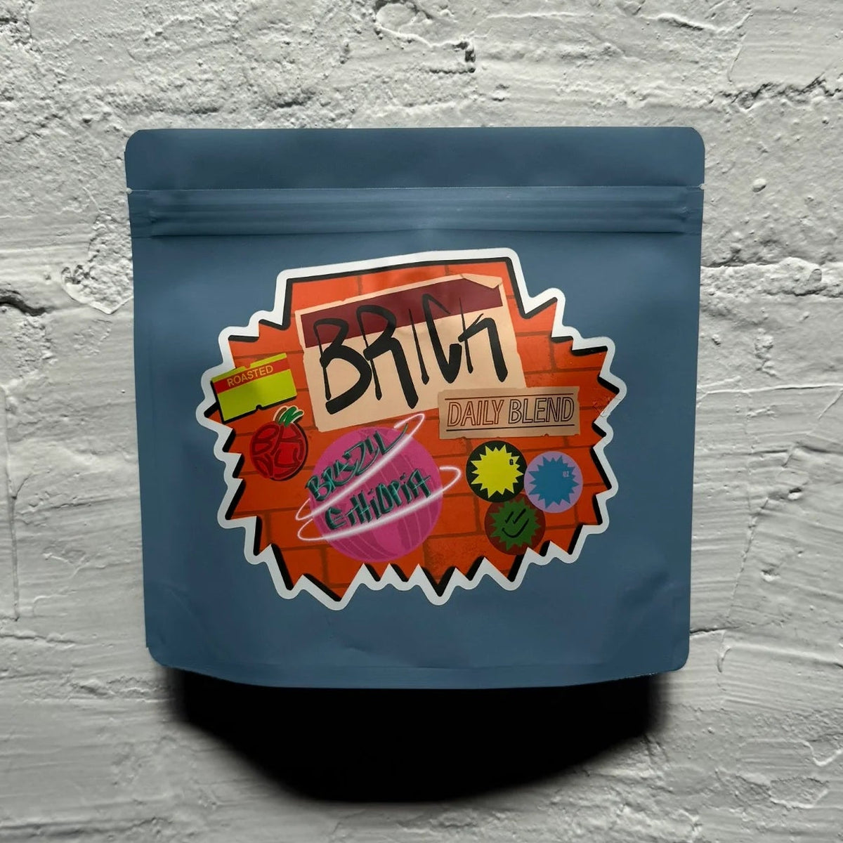 Blue packaging with colorful label on a textured gray background
