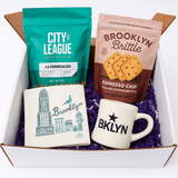 Gift set with 'City League' coffee, 'Brooklyn Brittle', and two mugs in a box.