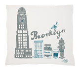 Tea Towel with Brooklyn-themed design featuring a clock tower, building, fire hydrant, and cup.
