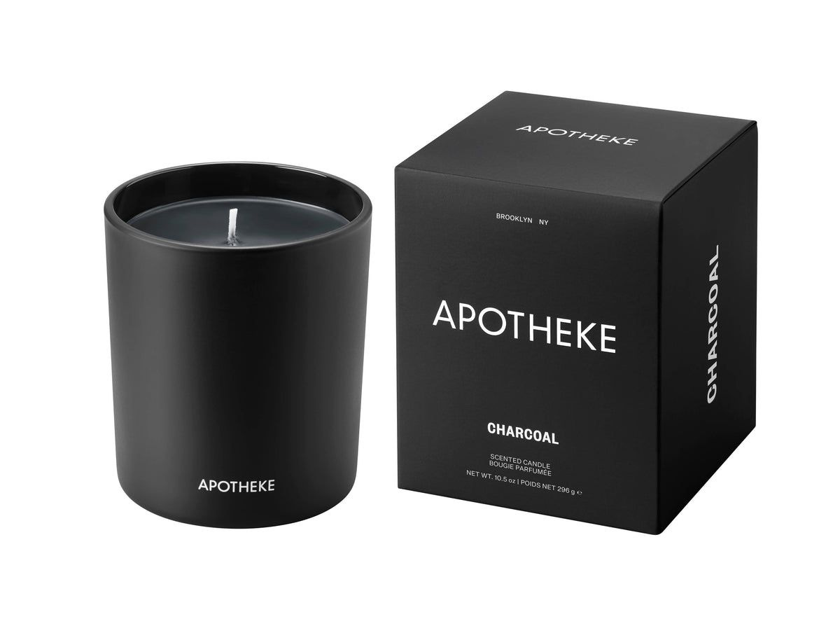 Black candle and packaging with 'Apotheke' branding on a white background