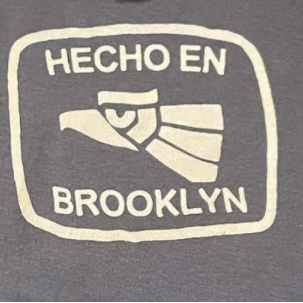 Gray sweatshirt with 'HECHO EN BROOKLYN' text and eagle graphic