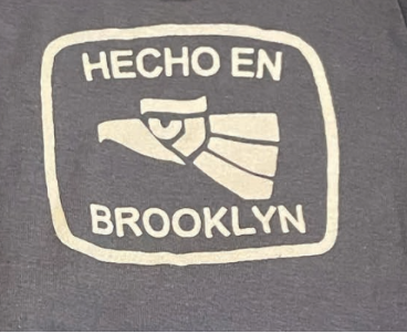 Gray sweatshirt with 'HECHO EN BROOKLYN' text and eagle graphic