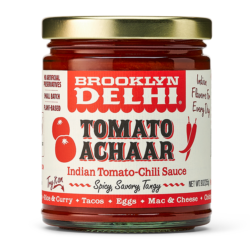 Jar of Brooklyn Delhi Tomato Achaar sauce with a gold lid on a white background