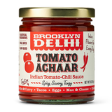 Jar of Brooklyn Delhi Tomato Achaar sauce with a gold lid on a white background