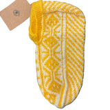 A traditional handmade yellow and white geometric patterned sock, known as a Patik, displayed on a wooden surface.