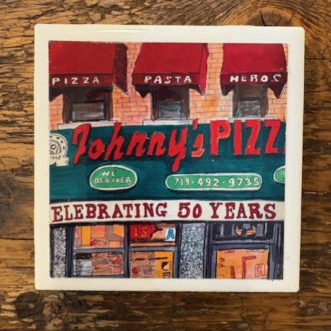 Coaster with illustration of Johnny's Pizza on a wooden surface